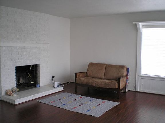 living room with wood burning fireplace.
