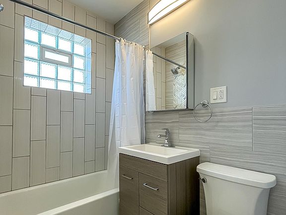New vanity, toilet, sink, mirror and lighting. Heat lamp