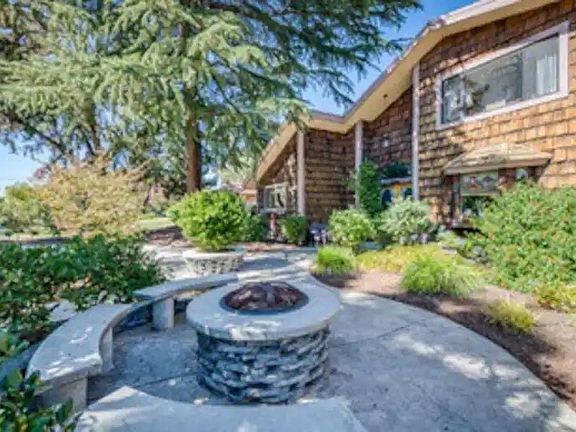 Semi-private front yard with fire pit and benches