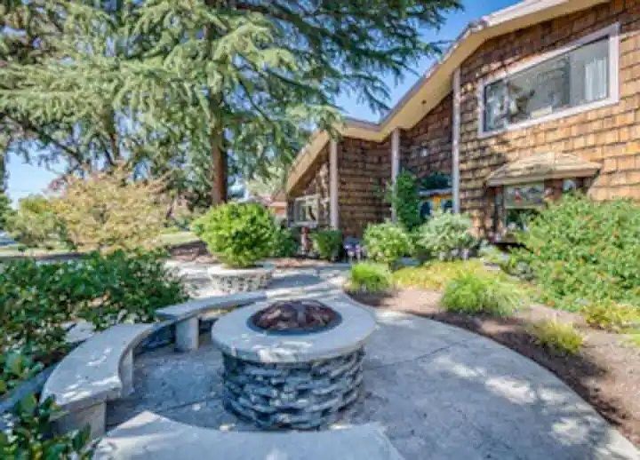 Semi-private front yard with fire pit and benches