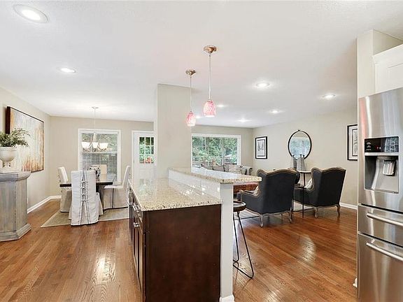 An abundance of granite countertops in this home, so much light stream in large windows.  Walk out to oversized deck, just steps away from the kitchen.