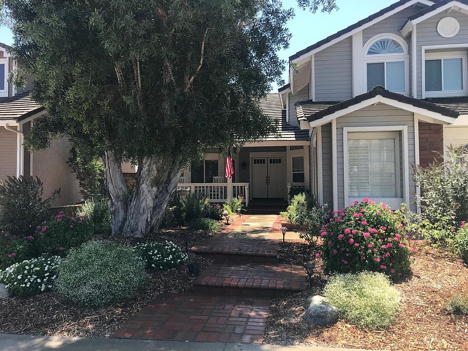 Front yard attracts butterflies and hummingbirds. Sit in one of two rocking chairs under a covered porch to enjoy the view.
