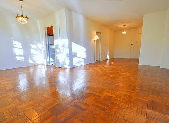 The large living room and "L" shape dining room with a bank of windows over looking tree lined Garth Road.  There is a door leading to a sunny private balcony.  The living room is 20'-0" x 12'-0" the foyer is an additional 10'-8" x 8'-2" and the dinig are