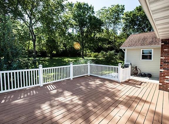Nice deck off the master bedroom & greatroom open to a lovely, parklike yard.