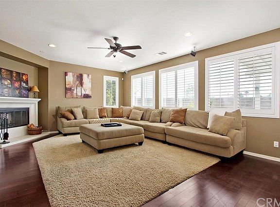 Family room with fireplace and plantation shutters