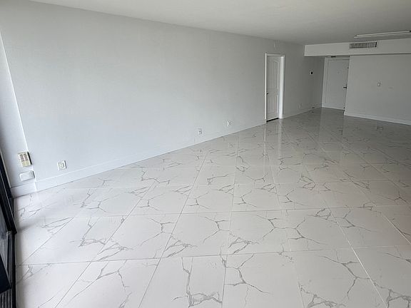 LIVING ROOM / DINING ROOM area with dimmable designer lighting, floor-to-ceiling impact windows & high quality Italian porcelain tiles throughout the entire apartment