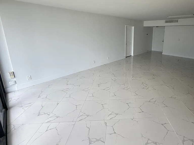 LIVING ROOM / DINING ROOM area with dimmable designer lighting, floor-to-ceiling impact windows & high quality Italian porcelain tiles throughout the entire apartment