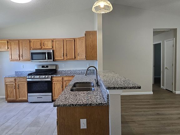 Kitchen, hallway to laundry, bathroom, and bedrooms 1 & 2