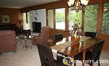 Dining rm & panoramic view of lake & forest