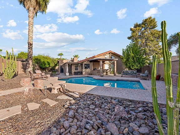 Huge backyard showing pool and covered BBQ area