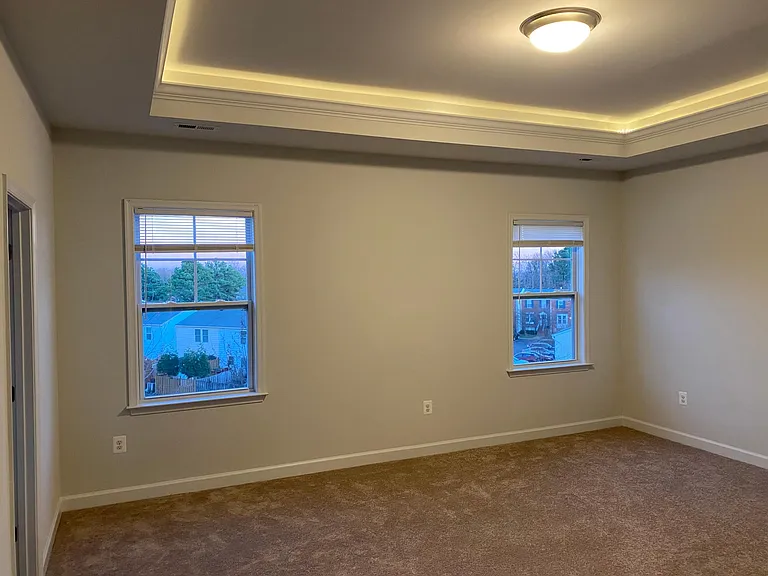 Master bedroom with tray ceiling and rope light