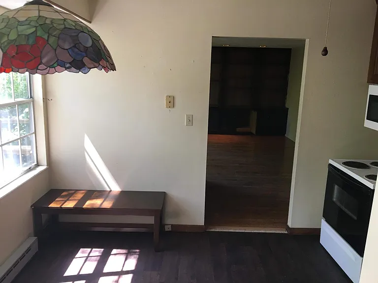 Stained glass light above dining table provides distinguished ambiance