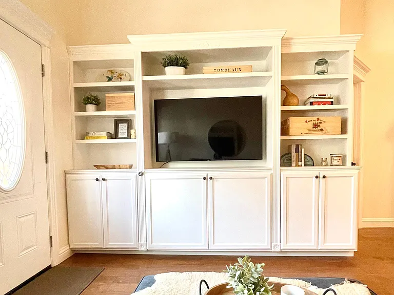 Entertainment center with smart TV, bookcases and storage