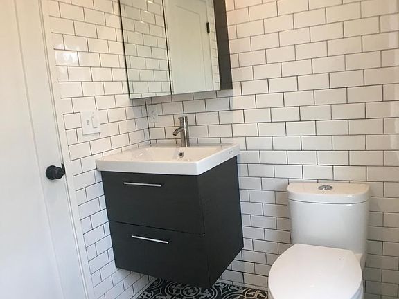 extra storage in behind mirror and 2 big drawers under sink