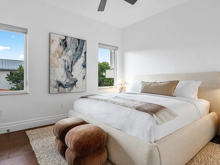 Comfortable Guest Bedroom with a plush king bed, soft woven rugs, and natural wood accents, all bathed in gentle natural light.