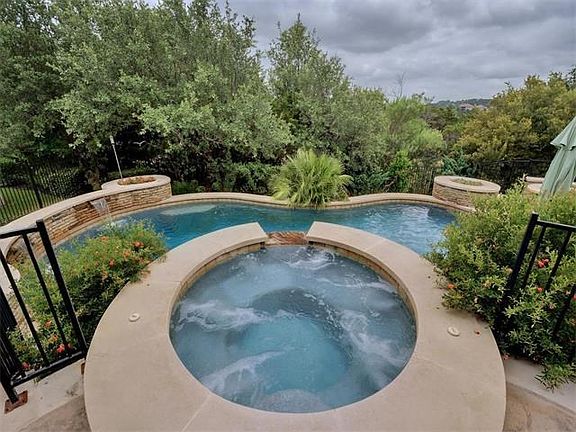 Stunning saltwater pool and hot tub with a VIEW and GREENBELT as the backdrop!