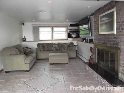 Family Room
						:
						Tiled floor, fireplace, built in shelves in this bright room.