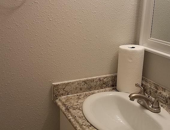 Bathroom has all new fixtures, single vanity with granite counter top, bathtub/shower, toilet. Small, but functional.