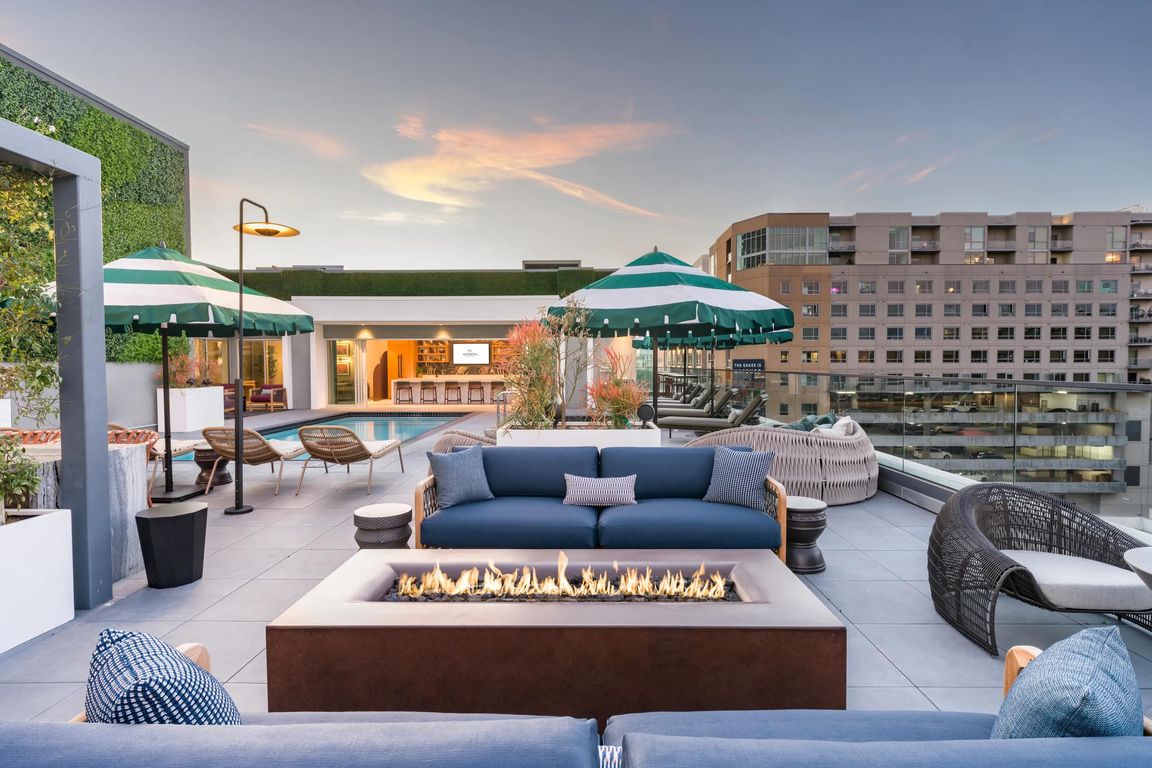 Relax in luxury at our resort-style rooftop pool with daybeds and sunshades!