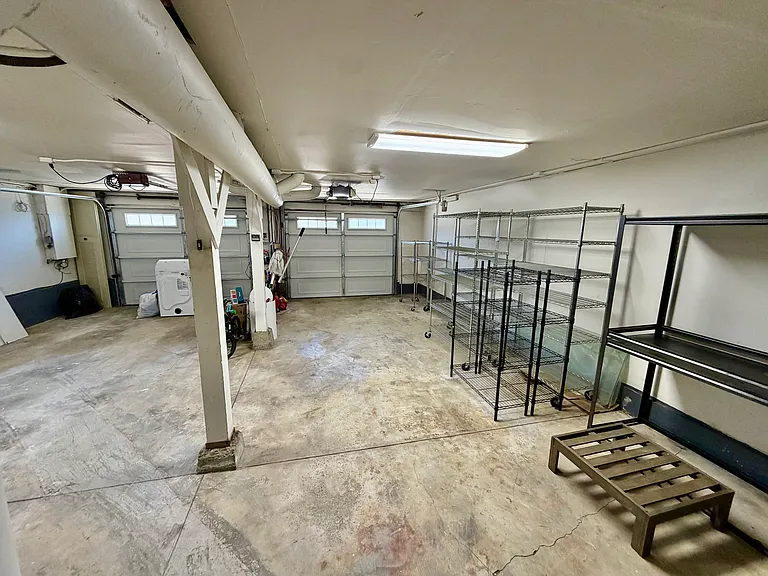 two full size car garage can fit four sub-compact vehicles with storage racks and new washer and dryer
