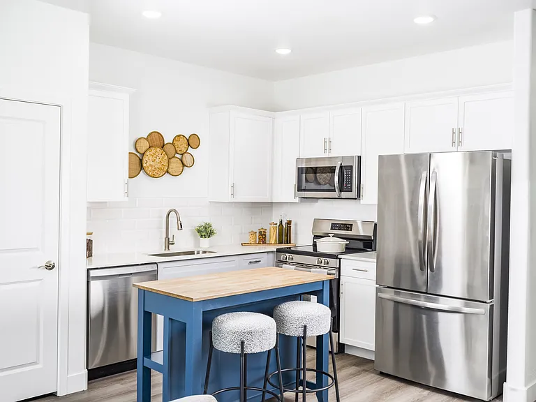 Cook in style at Aster Ridge! Our gourmet kitchens feature sleek quartz countertops, elegant white shaker cabinetry, and a designer tile backsplash.