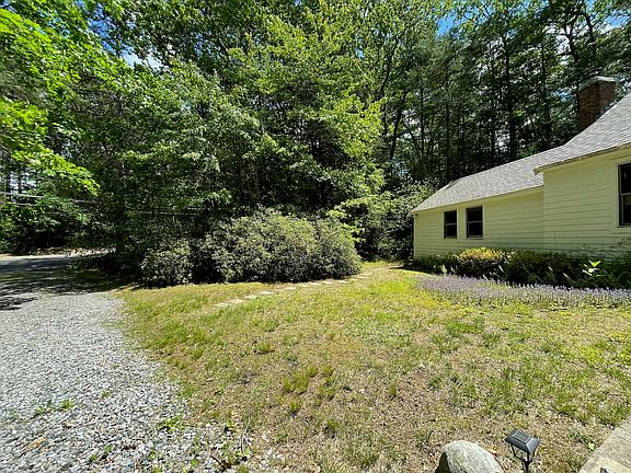 Dedicated parking area for the apartment is on the gravel driveway right at the end of the walkway.