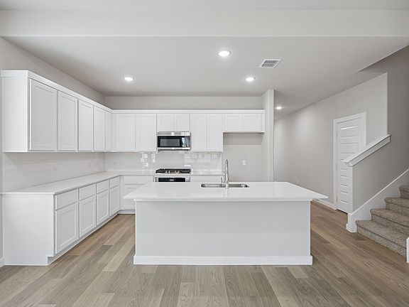 Kitchen in the Stanley II home plan by Trophy Signature Homes - REPRESENTATIVE PHOTO