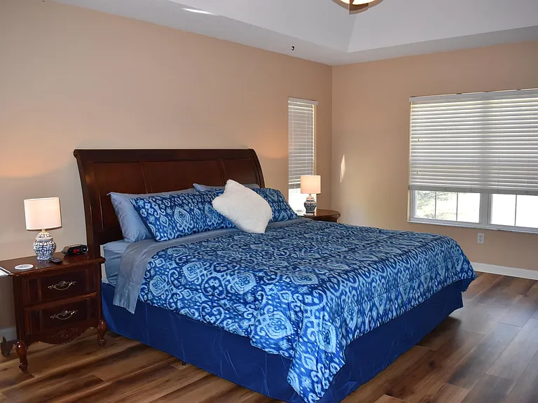 Spacious primary bedroom with king-sized bed