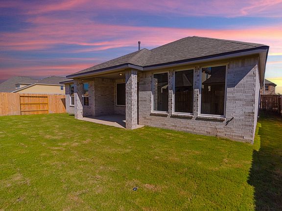 Back exterior with gorgeous yard and covered patio