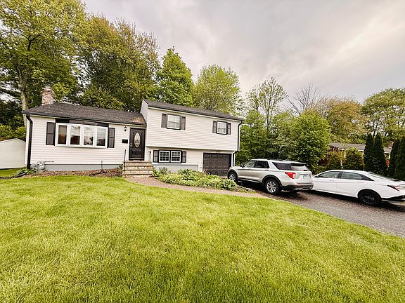 Driveway fits three cars.