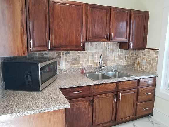 Kitchen with new appliances and cabinets.