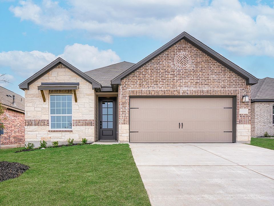Exterior of the Fannin with stone and brick exteriors and a two-car garage.