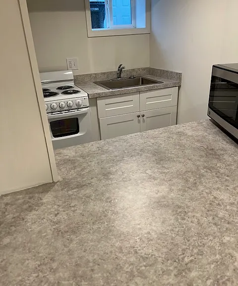 Kitchen equipped with refrigerator, full size range (not shown), microwave, garbage disposal