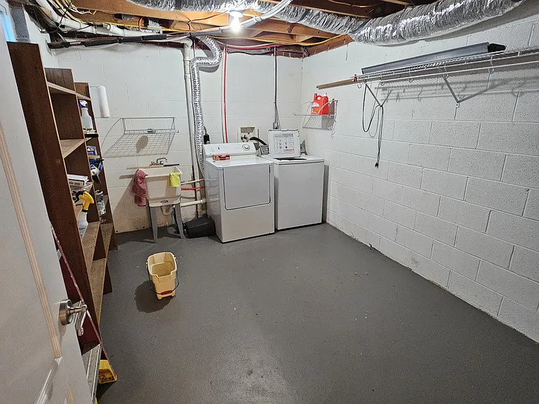 Full laundry room with washer and dryer, this is a dedicated laundry room for the downstairs apartment.