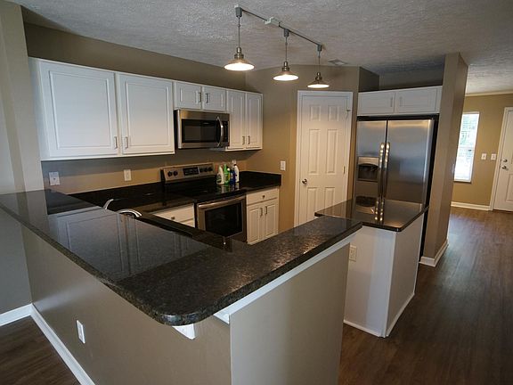View from the kitchen to the front door. There is a power room and closet just below the stairs