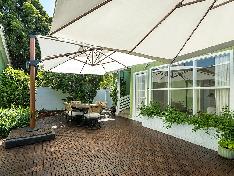 Private backyard retreat featuring a large patio for dining and entertaining, plus a lush lawn for play and relaxation.