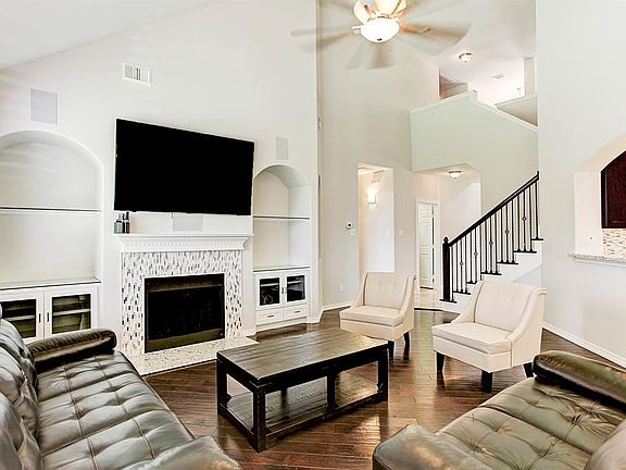 Another perspective of the living area.  Built-ins and a beautiful hearth for the gas fireplace are just some of the features of this home.  A very open floorplan and soaring ceilings make this the perfect spot for family get togethers.