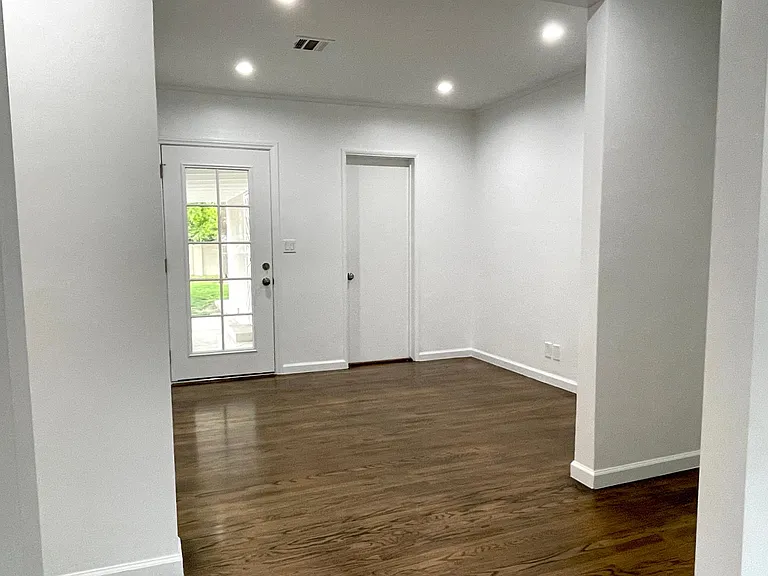 Den (great for office, gym or kids play area) toward the front door with access to the backyard.