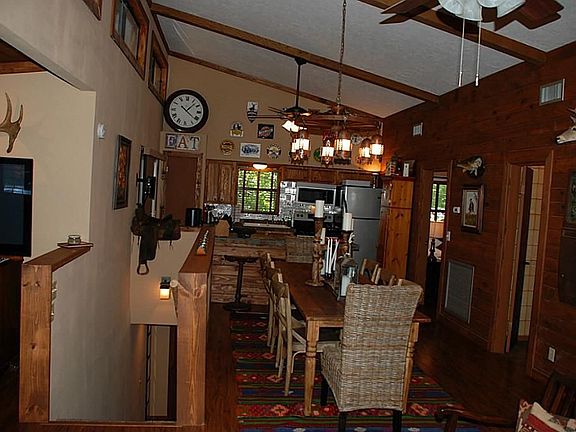 looking from living room to kitchen. Dining room is has a table large enough to seat 8 guests