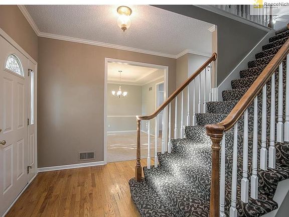 Once in side you will find beautiful hardwood floors, timeless designer stair carpet, new carpet and paint in every room.