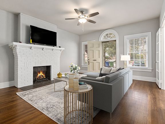 View of living room looking out to front porch. We do NOT have a working fireplace. It is for show only.