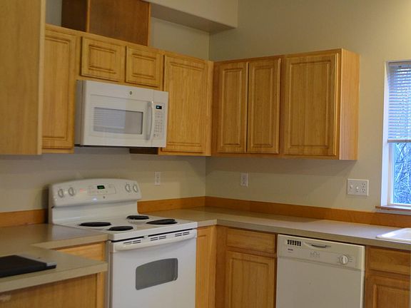 Kitchen of Unit A (remodel in progress for Unit B-kitchen cabinets to change color/new appliances/laminate flooring/new paint)