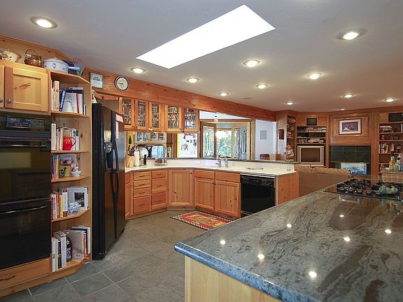 Country island kitchen( granite/corian) overlooks cozy "morning room".