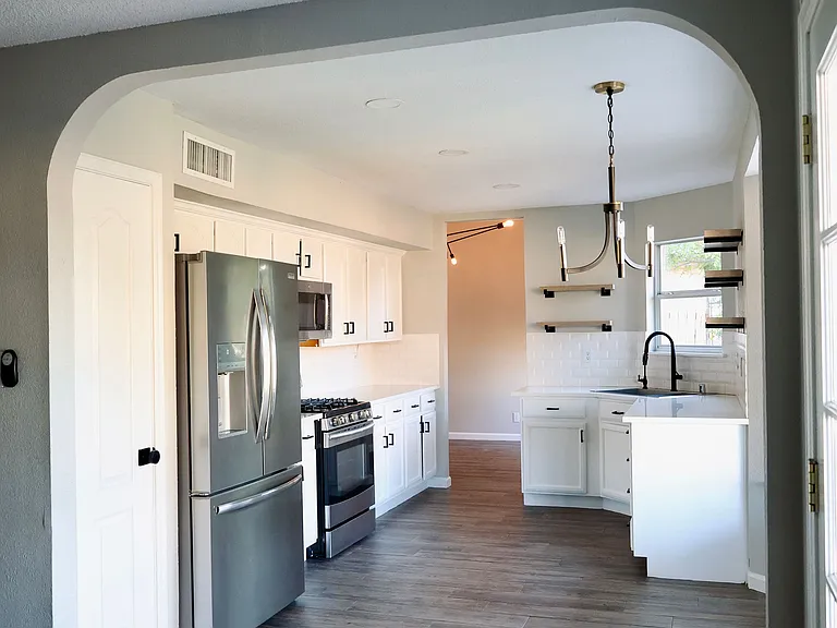Kitchen view. Refrigerator, microwave range, stove, dishwasher, water filtration system included.