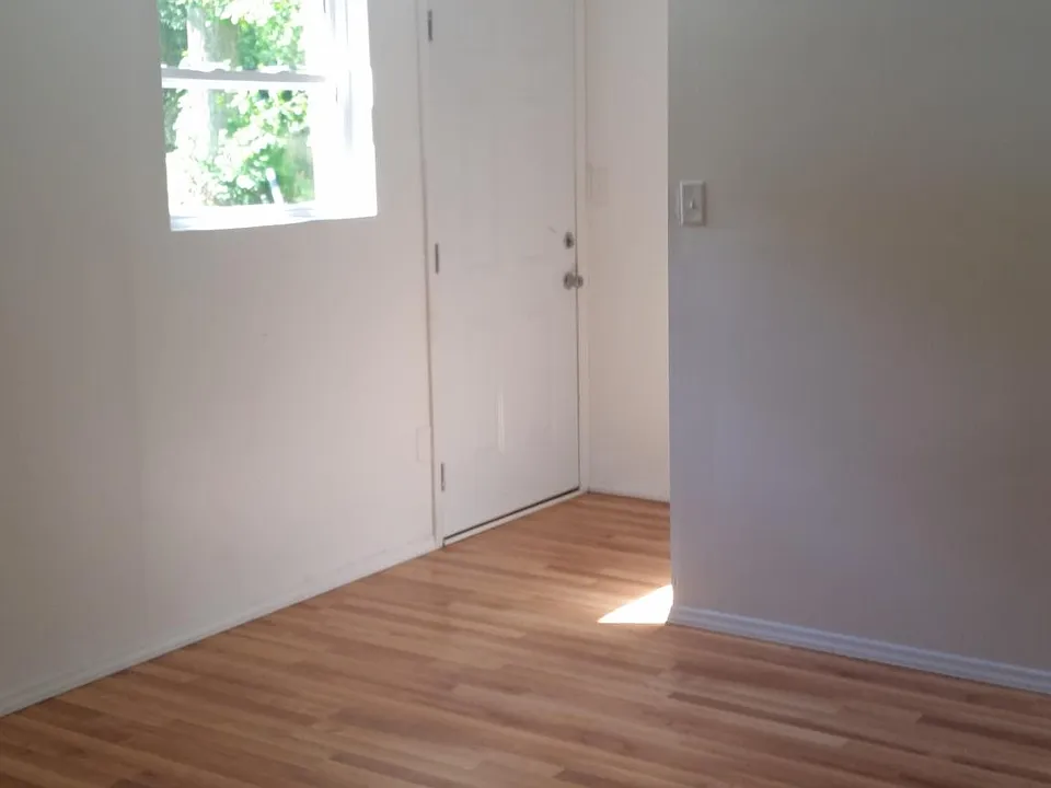 New laminate flooring bedroom & living room combined.