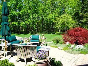 PATIO WITH WATER FEATURE AND BEAUTIFUL PLANTINGS