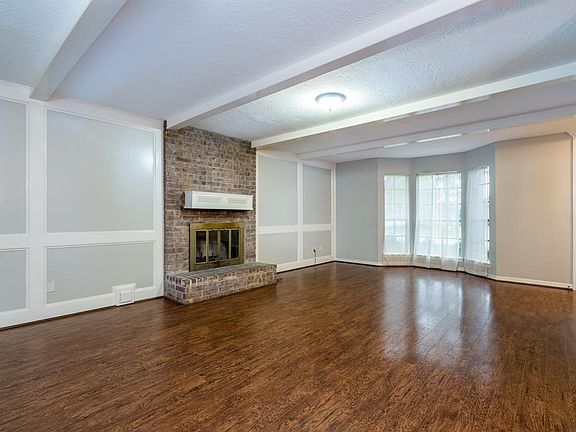 Extensive rich wood floors in the large living which could be set up with two seating areas.