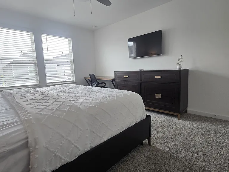Primary Bedroom , chest, TV and dedicated workspace
