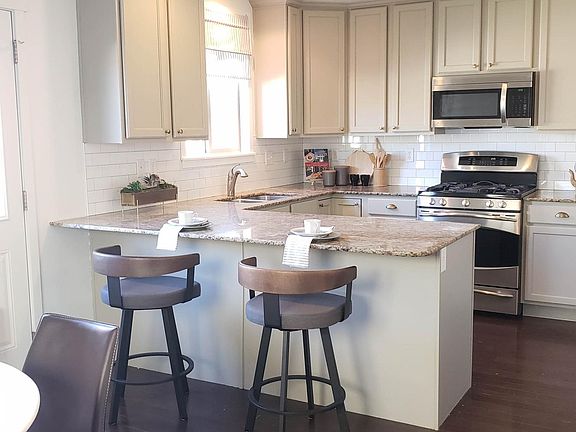 Eat in kitchen with granite counters and breakfast bar