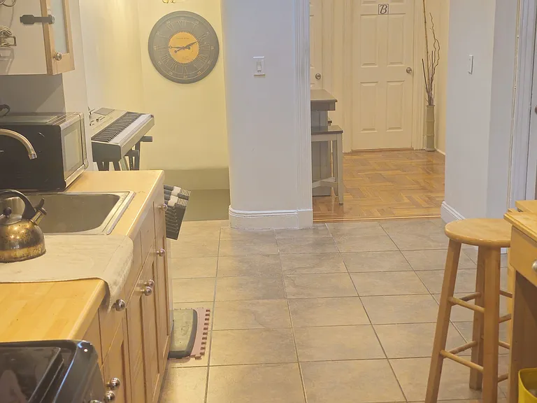 Looking from the Kitchen towards Exit Downstairs and Entry to Rooms.